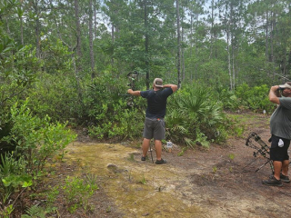 Young man aiming bow