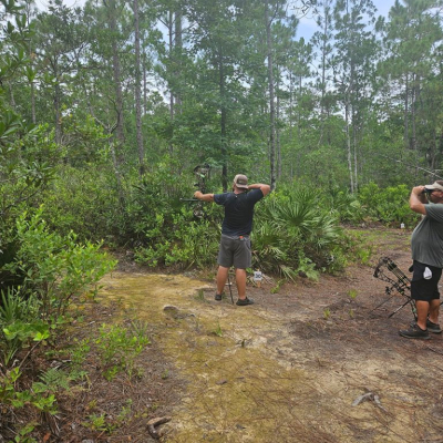 Young man aiming bow